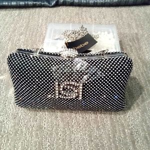 Bebe Clutch bag black and silver color.
